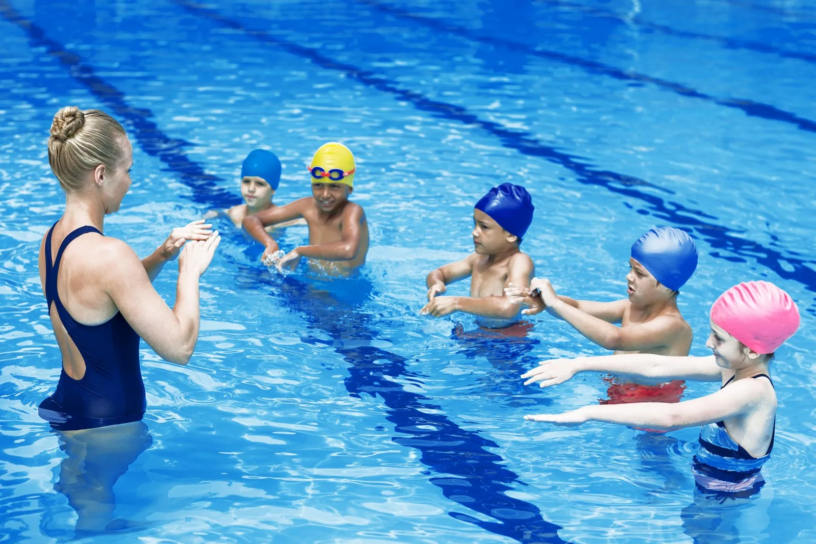 Instructor teaching a group of children in a swimming pool